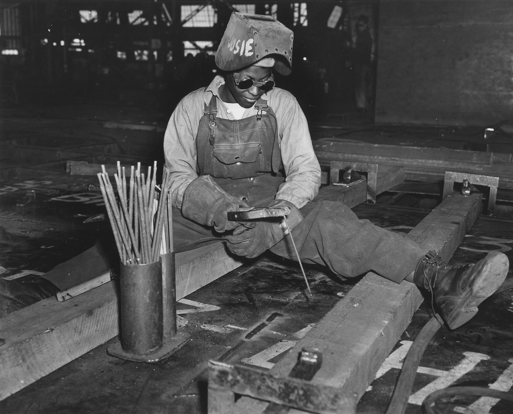 A welder helping construct the SS George Washington Carver at the Kaiser Shipyards 